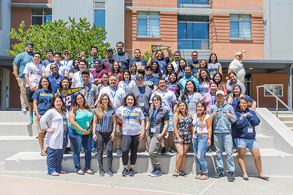 uc merced students taking a group picture on stairs