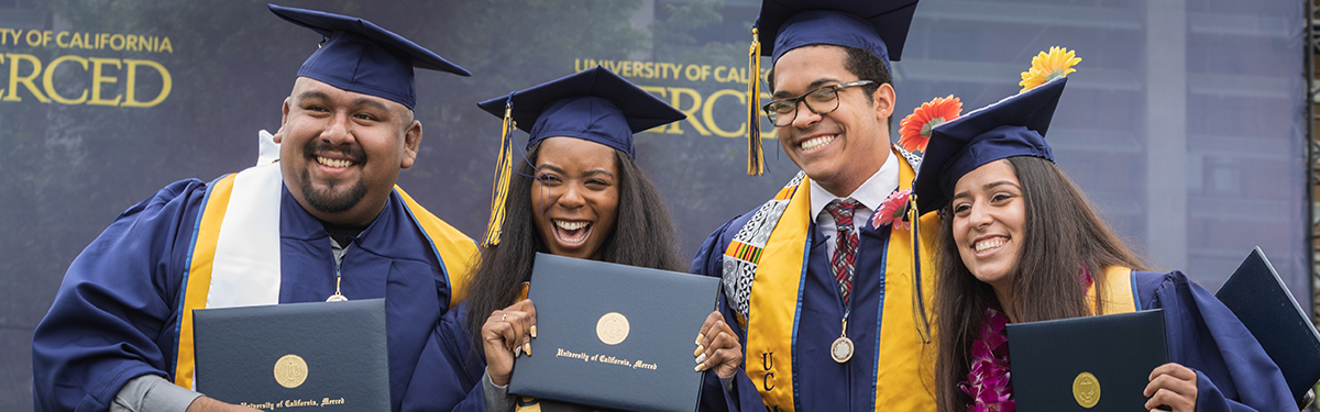 UC Merced graduates receiving their diplomas.