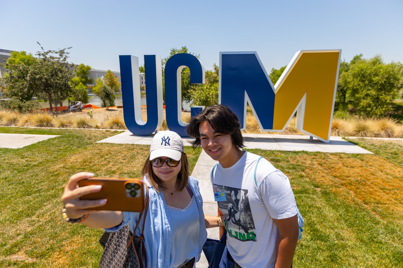 Family photo with big UCM sign