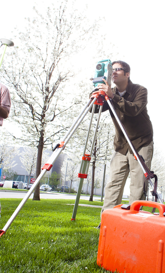 Engineering student surveying land