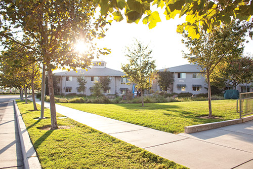 A picture of some of the Valley Terrace dorms from the outside on the sidewalk