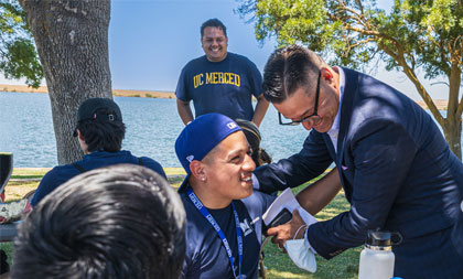 UC Merced Chancellor and admitted students enjoying a picnic at Lake Yosemite across from UC Merced