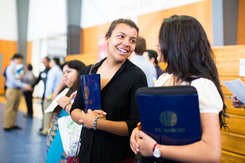 Counselors talking at event for UC Merced