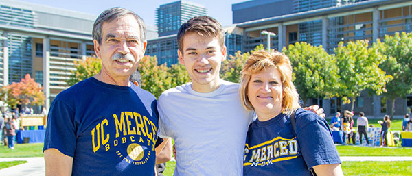 family in front of the beginnings sculpture