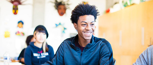 male student laughing in the classroom